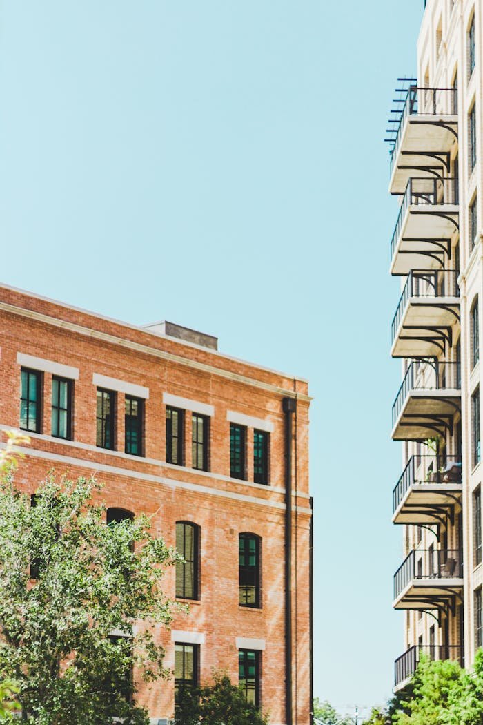 View of modern buildings with balconies against a clear blue sky in San Antonio.